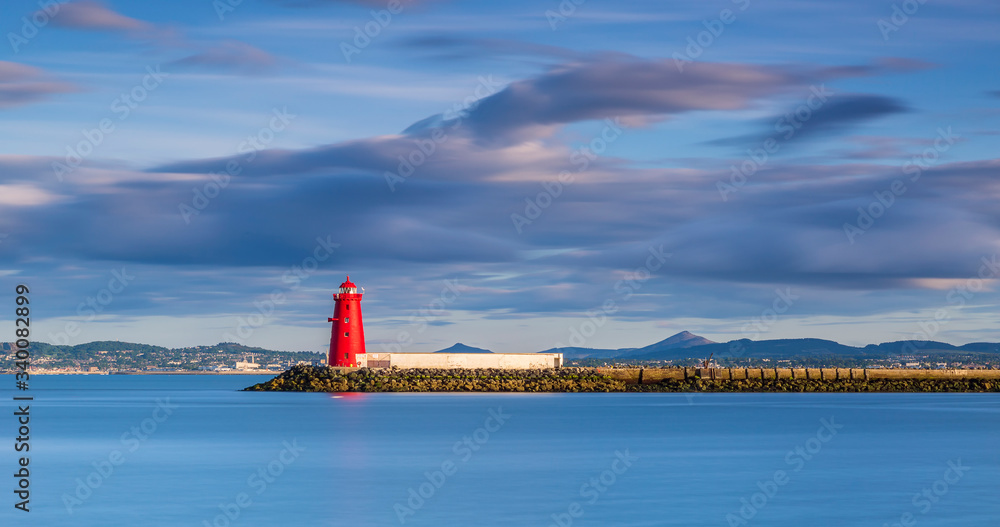 Fototapeta premium Aerial view Sunset Poolbeg lighthouse in Ireland, Dublin bay The lighthouse one of a formation of three is located on the Great South Wall South Bull Wall at the Port Ringsend's Poolbeg peninsula