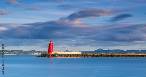 Aerial view Sunset Poolbeg lighthouse in Ireland, Dublin bay The lighthouse one of a formation of three  is located on the Great South Wall  South Bull Wall at the Port  Ringsend's Poolbeg peninsula photo