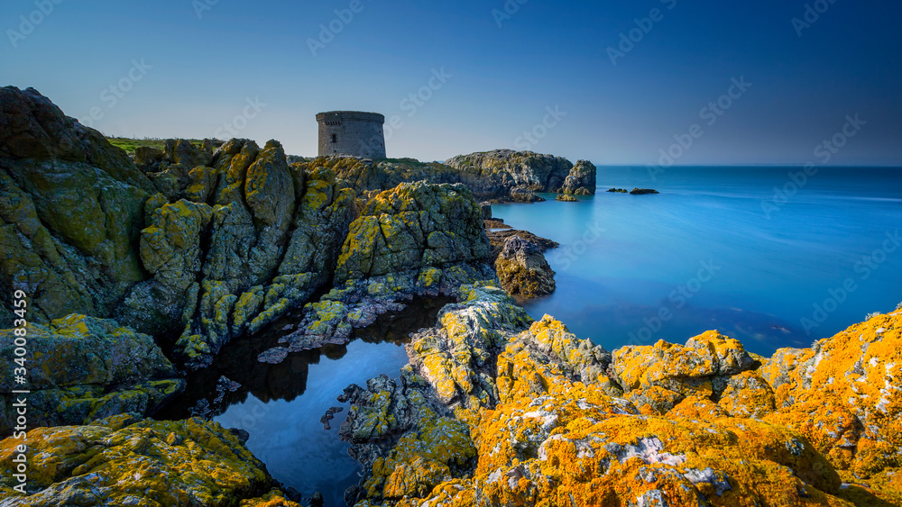 Fototapeta premium Ireland's Eye at twilight long exposure image, Ireland's Eye island cliffs.Howth, Dublin, Ireland Martello Tower