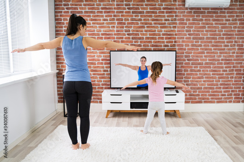 Family Doing Home Online Yoga Fitness Exercise © Andrey Popov