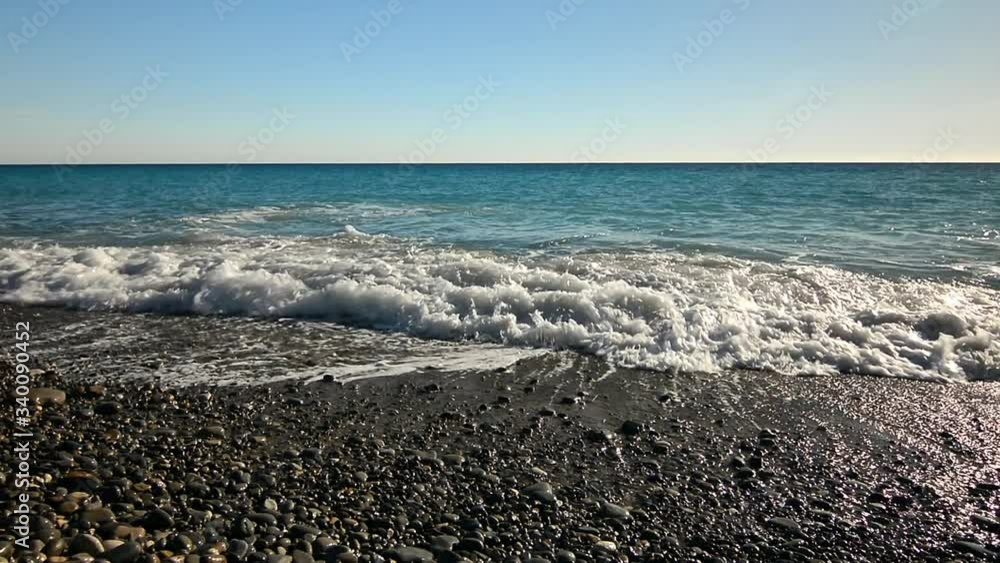 Sea waves, clear water and blue sky. Promenade des Anglais beach in Nice, France. French riviera.
Sea waves, clear water and blue sky. Promenade des Anglais beach in Nice, France. French riviera.