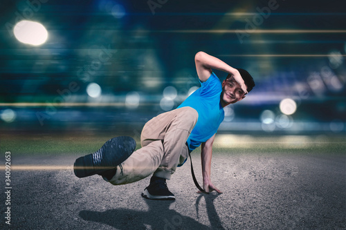 Young dancer doing break dance on the road