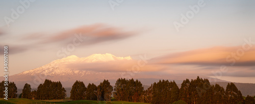 Snow caped Mt Ruapehu glowing at sunset