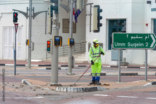 Photography Street cleaner seen on the empty Dubai street in the coastal Jumeirah area, during the COVID-19 pandemic 2020 lockdown of the city