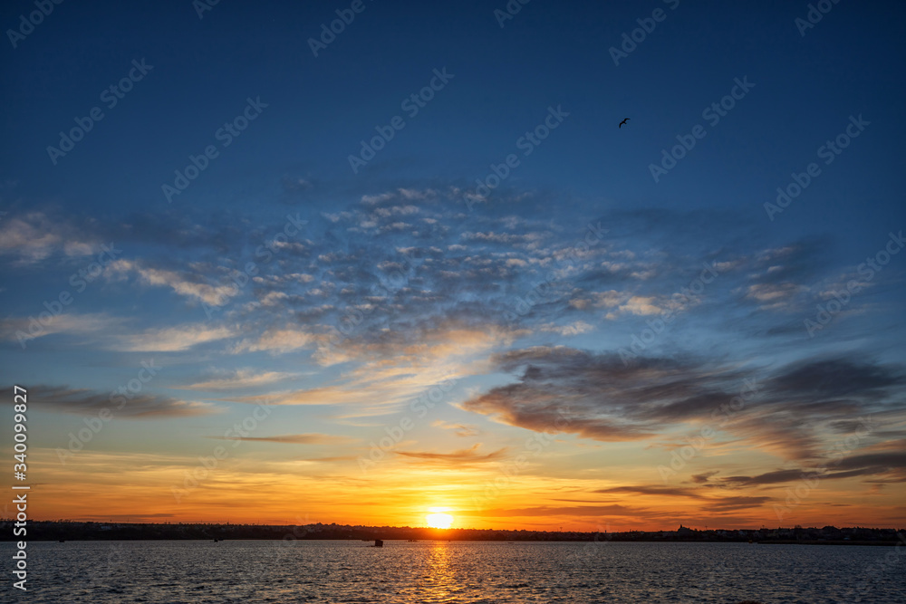 Beautiful sunset on the lake with clouds and reflections on the water Beautiful sunset on the lake with clouds and reflections on the water