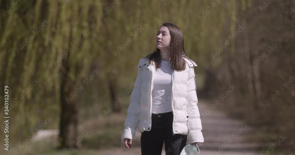 Portrait of sad woman behind bars wearing protective medical mask Portrait of sad woman behind bars wearing protective medical mask