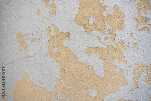Peeling paint from a stucco wall