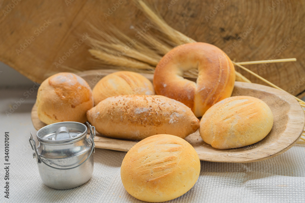 Baked breads on wooden table background.