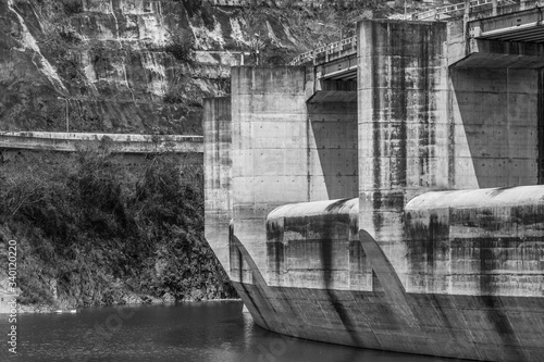 dramatic black and white image of Presa Jiguey dam on the lake in caribbean mountains of the dominican republic,