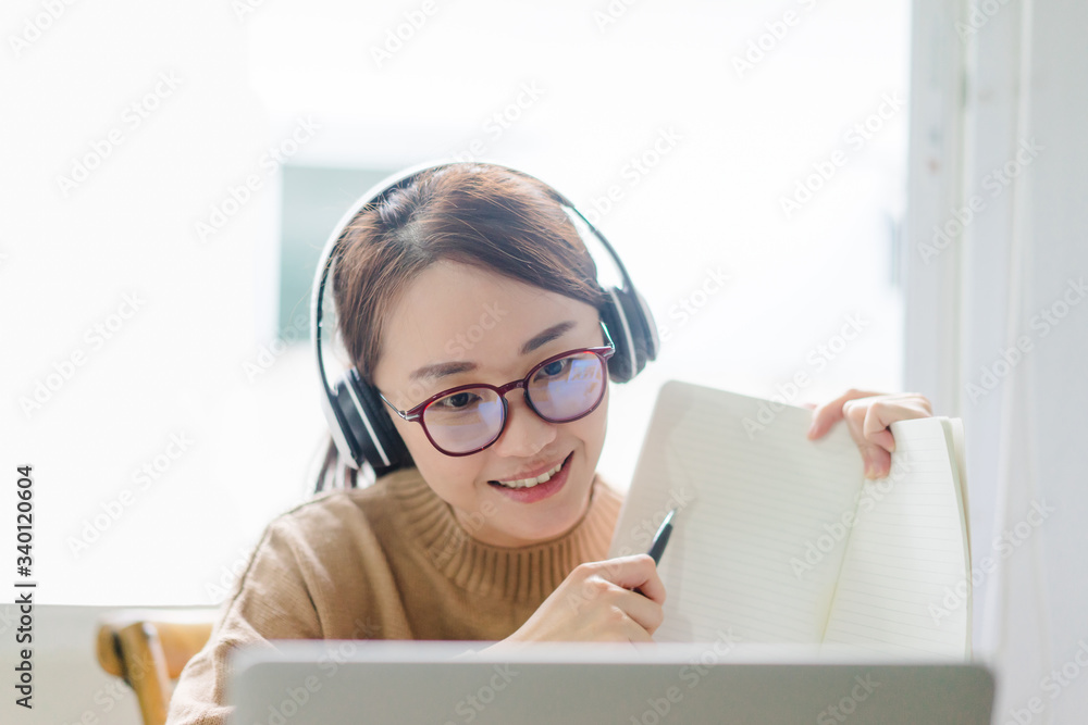 Smiling young asian woman enjoying teaching online at home.Covid-19 Coronavirus pandemic crisis, woman female teacher teach online class save lives and stay at home.Self isolation, Online Education. Smiling young asian woman enjoying teaching online at home.Covid-19 Coronavirus pandemic crisis, woman female teacher teach online class save lives and stay at home.Self isolation, Online Education.