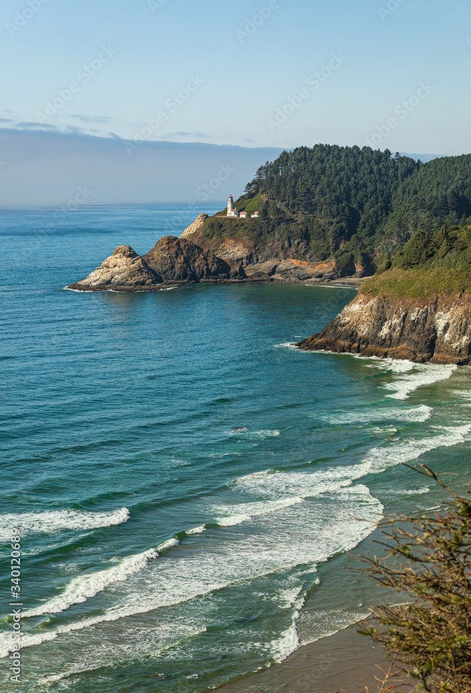 Vertical Image - Beach and cliffs leading to Heceta Head Lighthouse as seen from overlook with fog bank offshore.