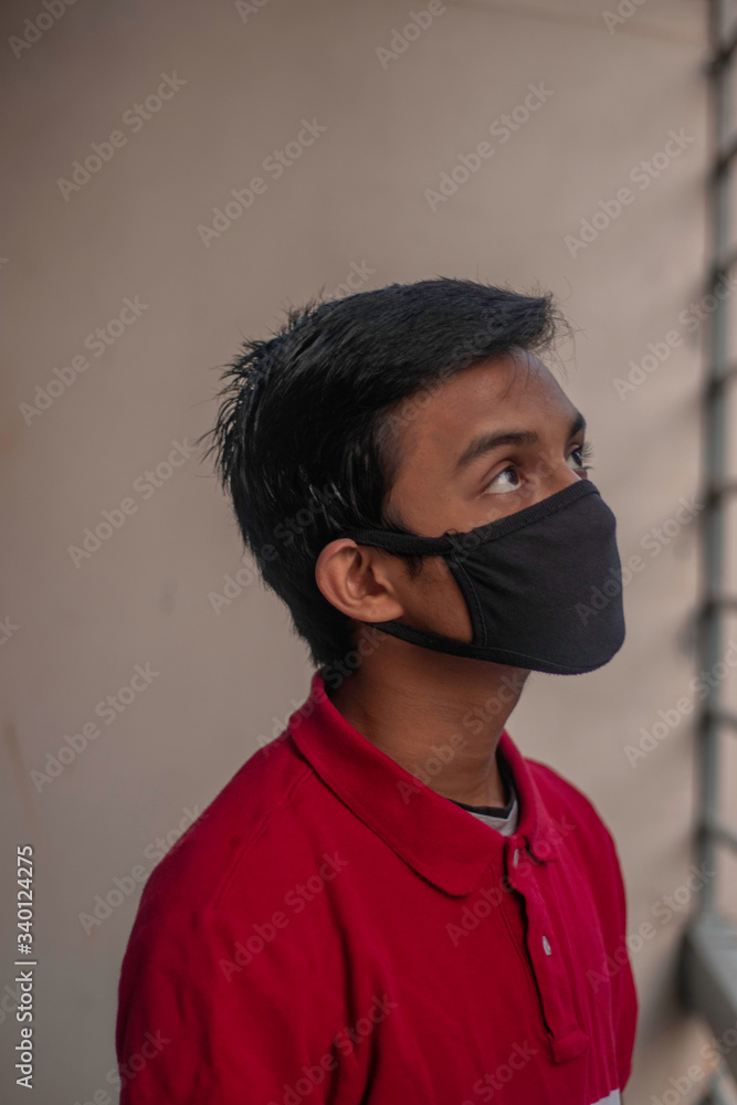 Concept of coronavirus quarantine. MERS-Cov. Novel coronavirus (2019-nCoV).Man wearing mask at home quarantine isolation and hoping for freedom of corona virus. Concept of coronavirus quarantine. MERS-Cov. Novel coronavirus (2019-nCoV).Man wearing mask at home quarantine isolation and hoping for freedom of corona virus.