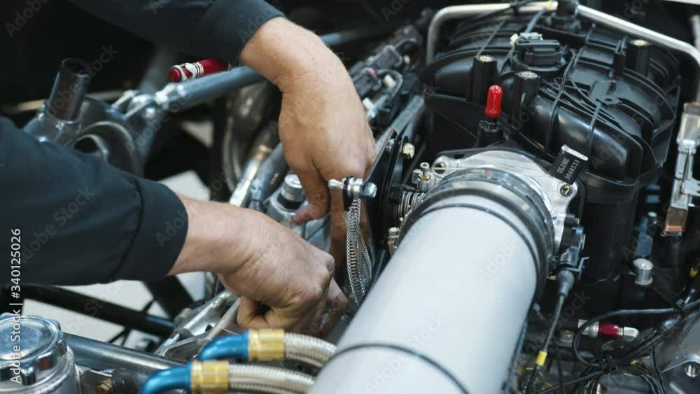 Car Repair by an Expert Mechanic, Close Up of Hands Working on Engine Car Repair by an Expert Mechanic, Close Up of Hands Working on Engine