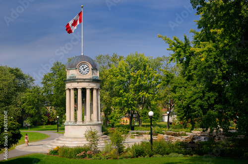 Old City Hall Clock Tower and fountain in Victoria Park Kitchener with Canadian flag photo