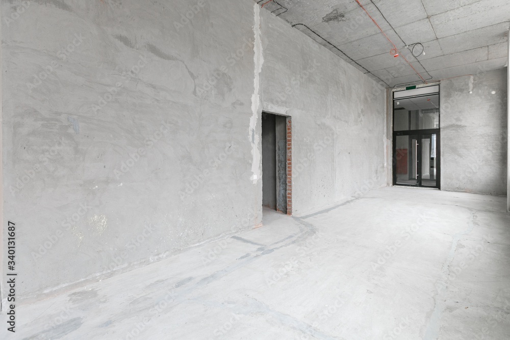 empty pure commercial office building undecorated in gray colors.open space office empty pure commercial office building undecorated in gray colors.open space office