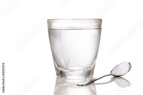 ORS or oral rehydration salt with glass of water and spoon