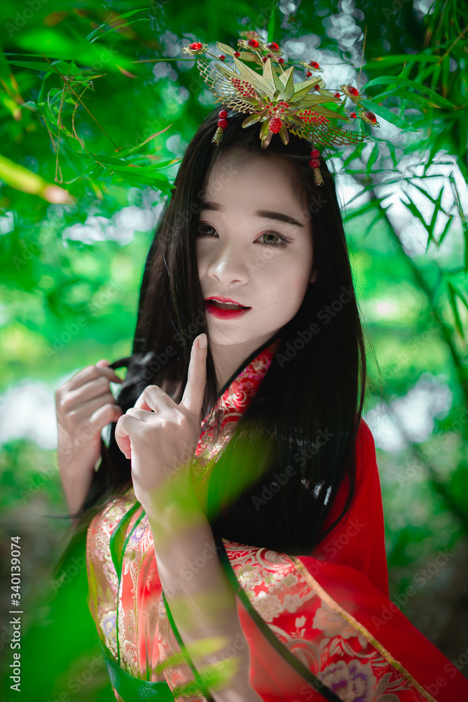 Portrait of beautiful asian woman wear ancient chinese dress style at the bamboo forest,Thailand people,Chinese movie scene Portrait of beautiful asian woman wear ancient chinese dress style at the bamboo forest,Thailand people,Chinese movie scene