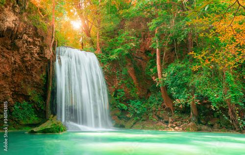 Beautiful waterfall with sunlight in autumn forest at Erawan National Park  Thailand  Nature landscape 