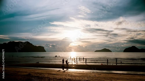 Time lapse. Photos are many people on the beach. Colorful sky, mountains and sea in the bay. Tranquil scene, idyllic atmosphere. 4K