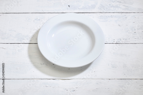Blank clean white plate on white table