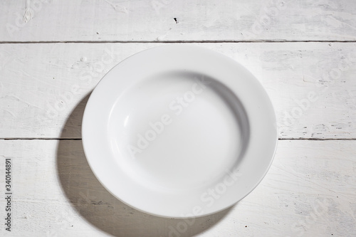 Blank clean white plate on white table