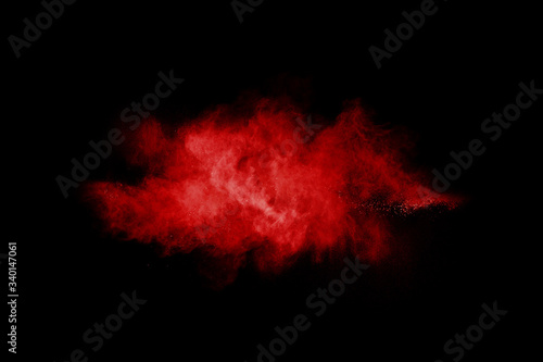abstract red powder explosion on black background.abstract red powder splatted on black background. Freeze motion of red powder exploding. © wooddy7