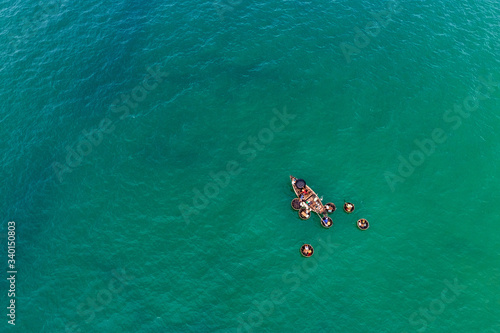Top view or aerial view of white beach with long tail boats of fisherman in summer of tropical in Vinh Thanh, Hue, Vietnam.