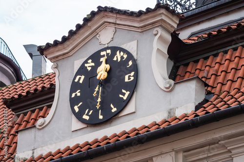 Hebrew Clock that Runs Counterclockwise on the Jewish Town Hall in Prague, Czech Republic photo