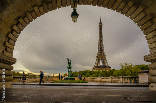 Paris, France - Eiffel Tower view from a Parisian corner, beautiful scenery in the rainy afternoon  © Huntergol