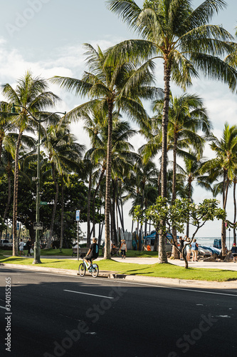 Waikiki, Honolulu - August 27th 2019: The view from Kalakaua Ave of people enjoying the beautiful sunny Waikiki Beach in the morning. © Nick