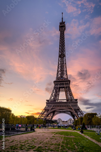 Paris  France 2017 Public park with grassy lawns and walking paths located at the foot of the Eiffel Tower during sunset