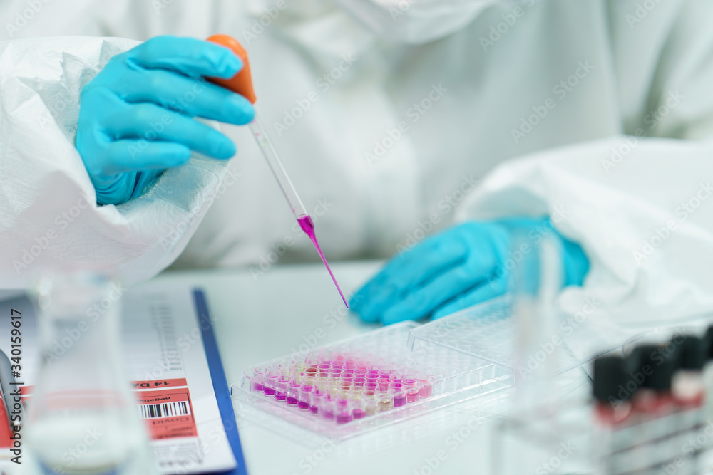 Scientist in laboratory with biological tube for analysis and sampling of Covid-19. Scientist in laboratory with biological tube for analysis and sampling of Covid-19.