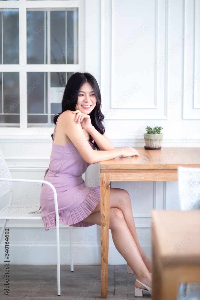 Beautiful Asian woman wear dress pants pink. Sitting on chair and white background. Beautiful Asian woman wear dress pants pink. Sitting on chair and white background.