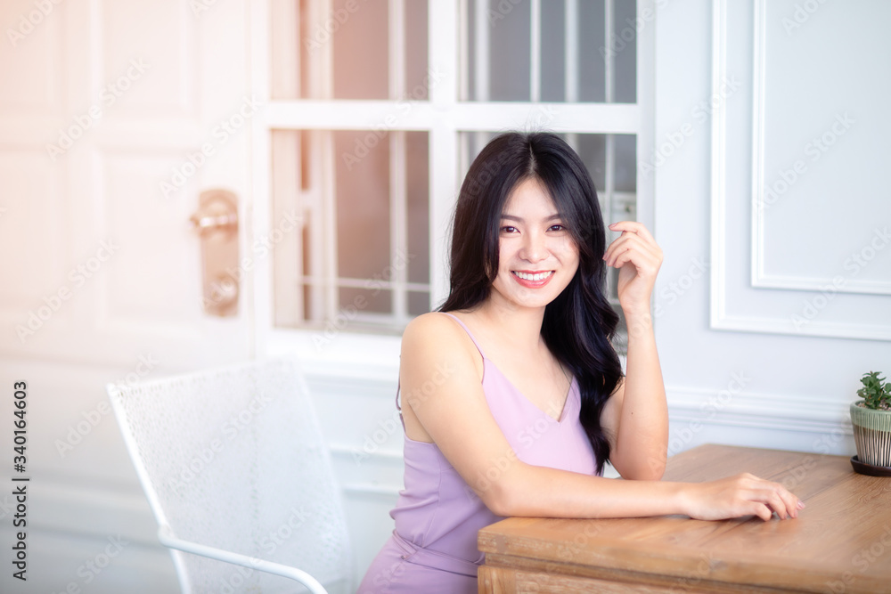 Beautiful Asian woman wear dress pants pink. Sitting on chair and white background. Beautiful Asian woman wear dress pants pink. Sitting on chair and white background.