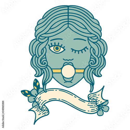 tattoo with banner of winking female face with ball gag