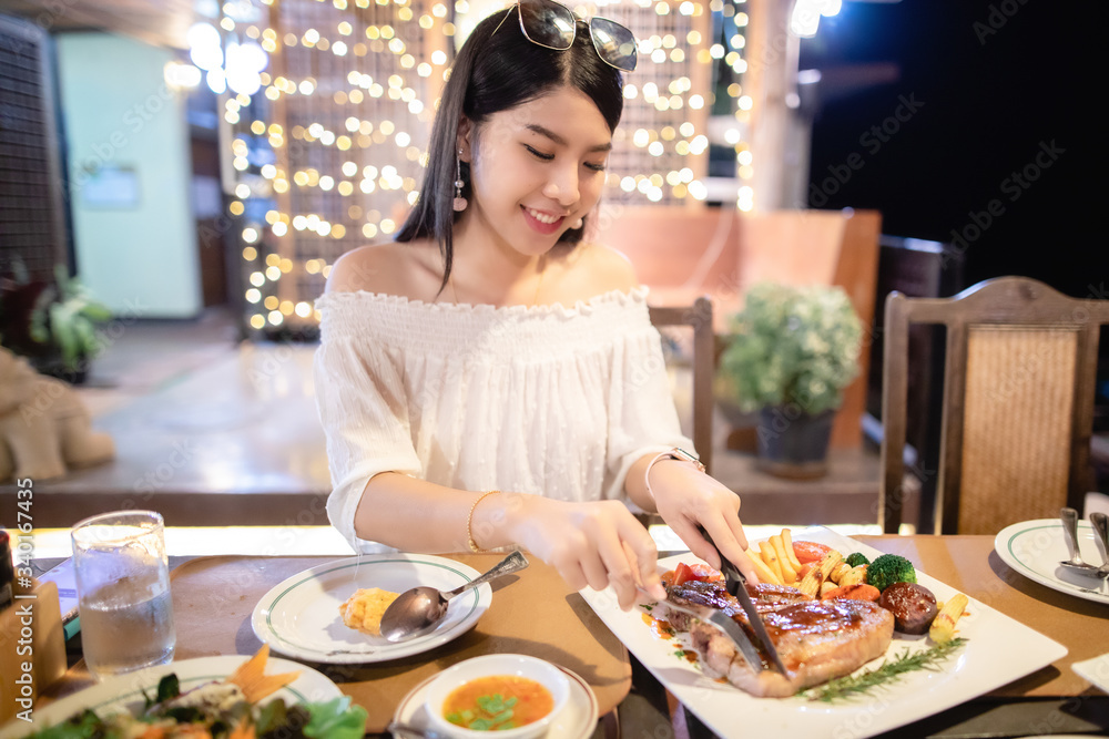 Beautiful Asian woman have dinner in a restaurant. Beautiful Asian woman have dinner in a restaurant.
