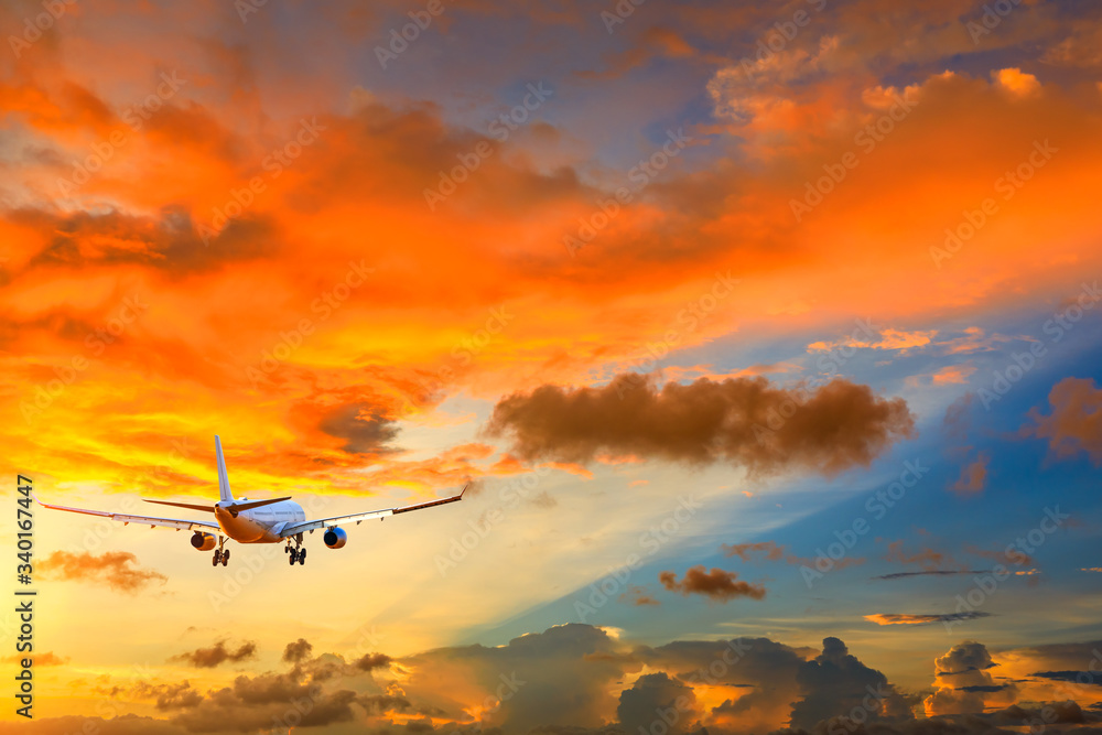 Fototapeta premium Commercial airplane flying in beautiful sky at sunset,travel concept.
