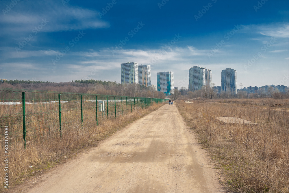Perspective of a road with houses on the horizon