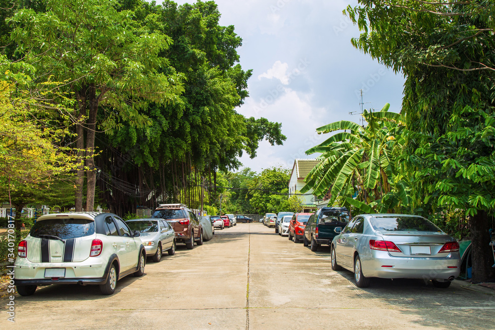 Many car parking at side village road with home and many cars parking in working day while lockdown from covid .