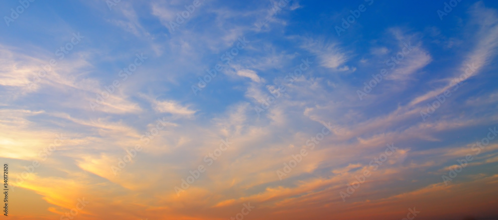Cloudy sky and bright sunrise over the horizon. Wide photo.