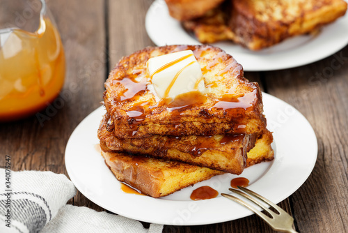 French toasts with butter and caramel sauce for breakfast.