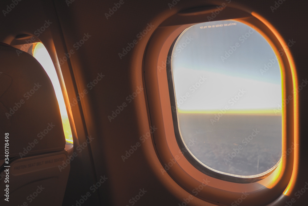 The morning sun shone through the glass on the plane to welcome tourists before arriving at the airport.