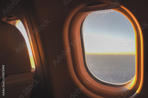 The morning sun shone through the glass on the plane to welcome tourists before arriving at the airport.