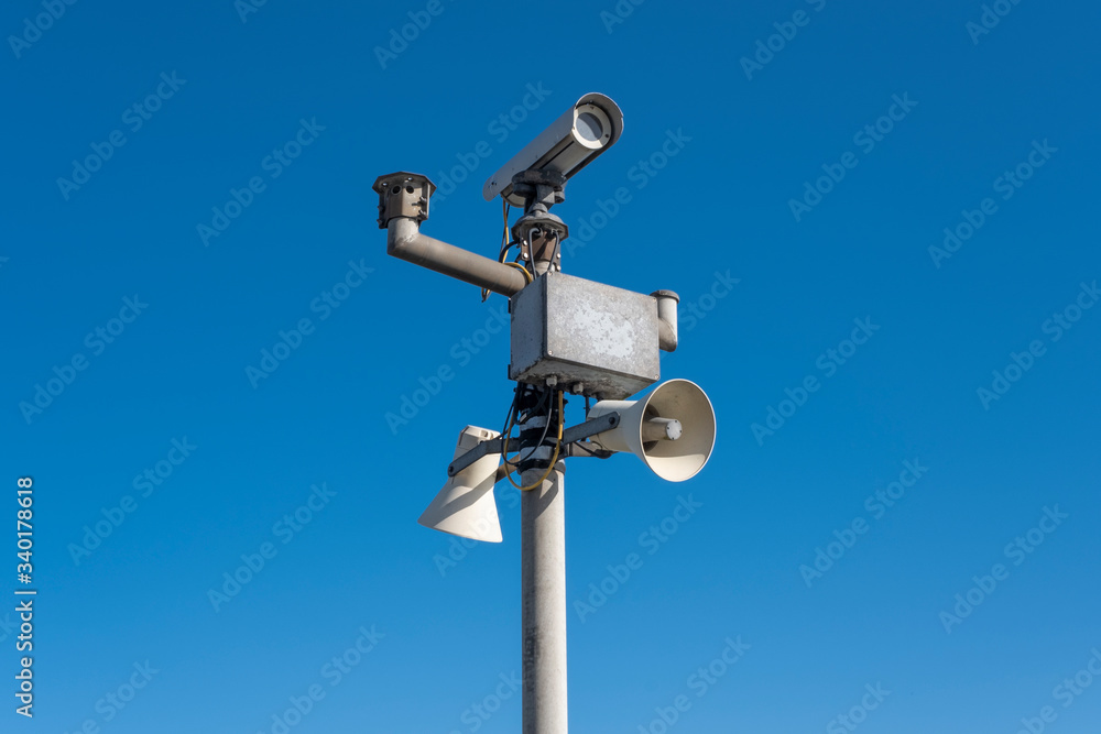 Security camera's outside with blue sky backdrop Security camera's outside with blue sky backdrop