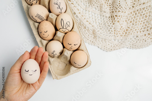 Easter eggs and easter bunny on white background with copy space. Easter background. Top view