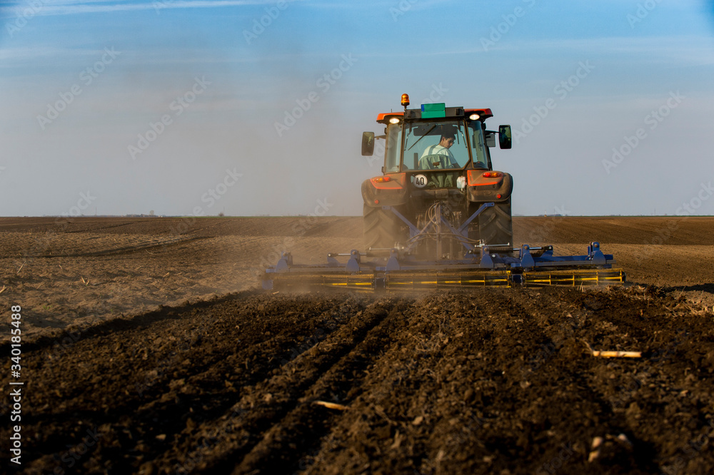 Fototapeta premium Tractor working in the field