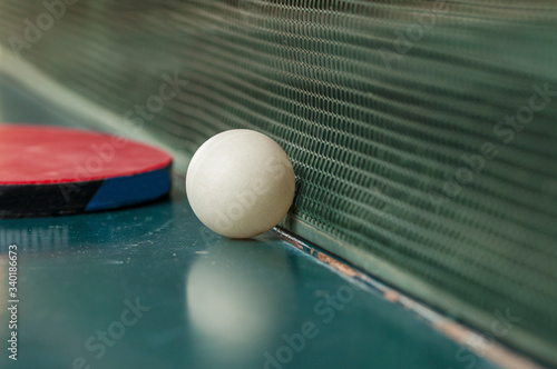 Ping pong table, rackets and balls in a sport hall. Table tennis sport concept © finchmaystor