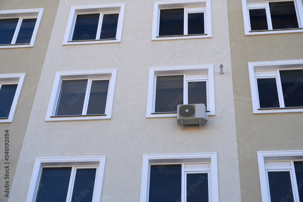 one air conditioner outside unit on a facade of residential building