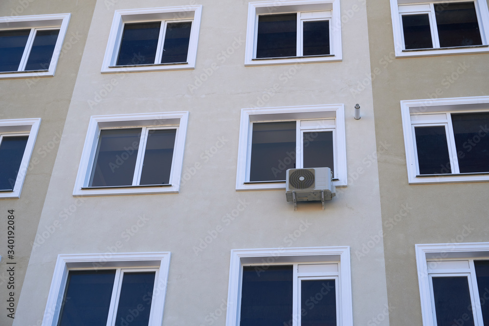 one air conditioner outside unit on a facade of residential building one air conditioner outside unit on a facade of residential building