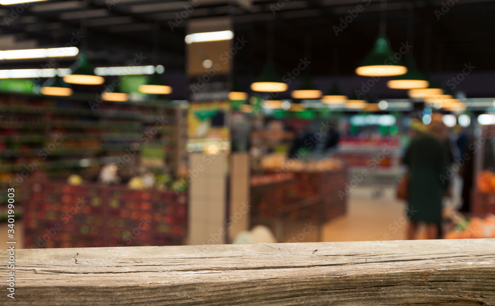 Supermarket background, Counter over blur grocery background, Wooden desk, table, shelf and blur woman shopping at supermarket, Wood counter for grocery store retail product display backdrop, template Supermarket background, Counter over blur grocery background, Wooden desk, table, shelf and blur woman shopping at supermarket, Wood counter for grocery store retail product display backdrop, template
